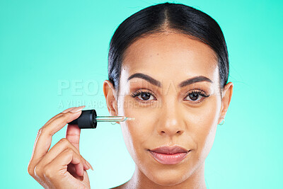 Buy stock photo Beauty, portrait and oil by woman in studio in skincare, wellness or cosmetic on blue background. Face, serum and girl with facial product for skin, anti aging or collagen, retinol or hyaluronic acid