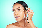 Skincare, oil and black woman in studio for beauty, wellness or cosmetics on blue background. Face, serum and girl with facial product for skin, anti aging or collagen, retinol or hyaluronic acid