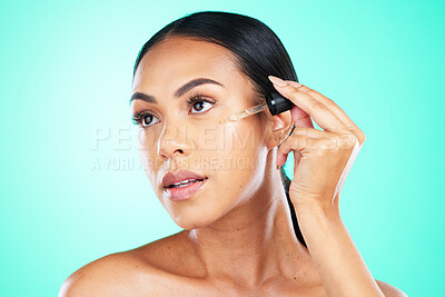Buy stock photo Skincare, oil and black woman in studio for beauty, wellness or cosmetics on blue background. Face, serum and girl with facial product for skin, anti aging or collagen, retinol or hyaluronic acid