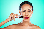 Red lipstick, woman and wink of a beauty model with cosmetics product isolated. Studio, cosmetic and skincare of a young person with skin glow from dermatology with blue background and mockup 