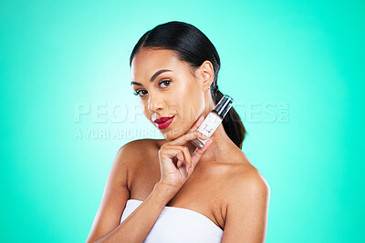 Buy stock photo Makeup, beauty and portrait of a woman in studio with facial serum for skincare treatment. Cosmetics, face and female model from Mexico with natural self care routine isolated by turquoise background