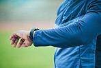 Time, watch and hand of a fitness man watching fitness, run and training results on a smartwatch. Workout tech, sports and exercise app monitor outdoor with an athlete with blurred background 