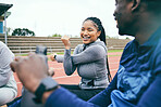 People, fitness and stretching for sports exercise, workout or training together on the stadium track. Black woman and friends in warm up stretch getting ready for athletics sport, running or race