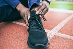 Sports, feet and man with ankle pain from exercise, workout and marathon training in stadium. Fitness, runner and shoes of athlete with joint strain, injury and arthritis from running on field track