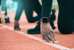 Athlete, runner and fitness person at start of a race on a sports track for exercise, workout or fitness. Running, sprint and closeup of runner ready for training as wellness, competition and health