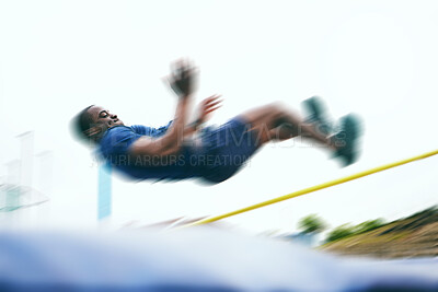Buy stock photo Athletics, fitness and high jump by man at a stadium for training, energy and cardio with blur and speed. Jumping, athlete and male outdoors for performance, endurance and competition on mock up