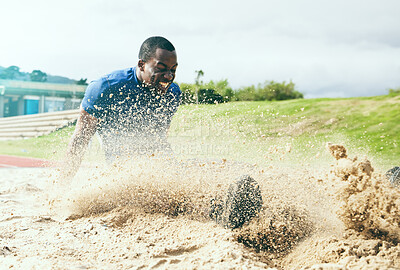 Buy stock photo Long jump, fitness and black man in the sand for sports, exercise and competition in the USA. Energy, speed and African athlete training for a sport challenge, jumping and landing with power