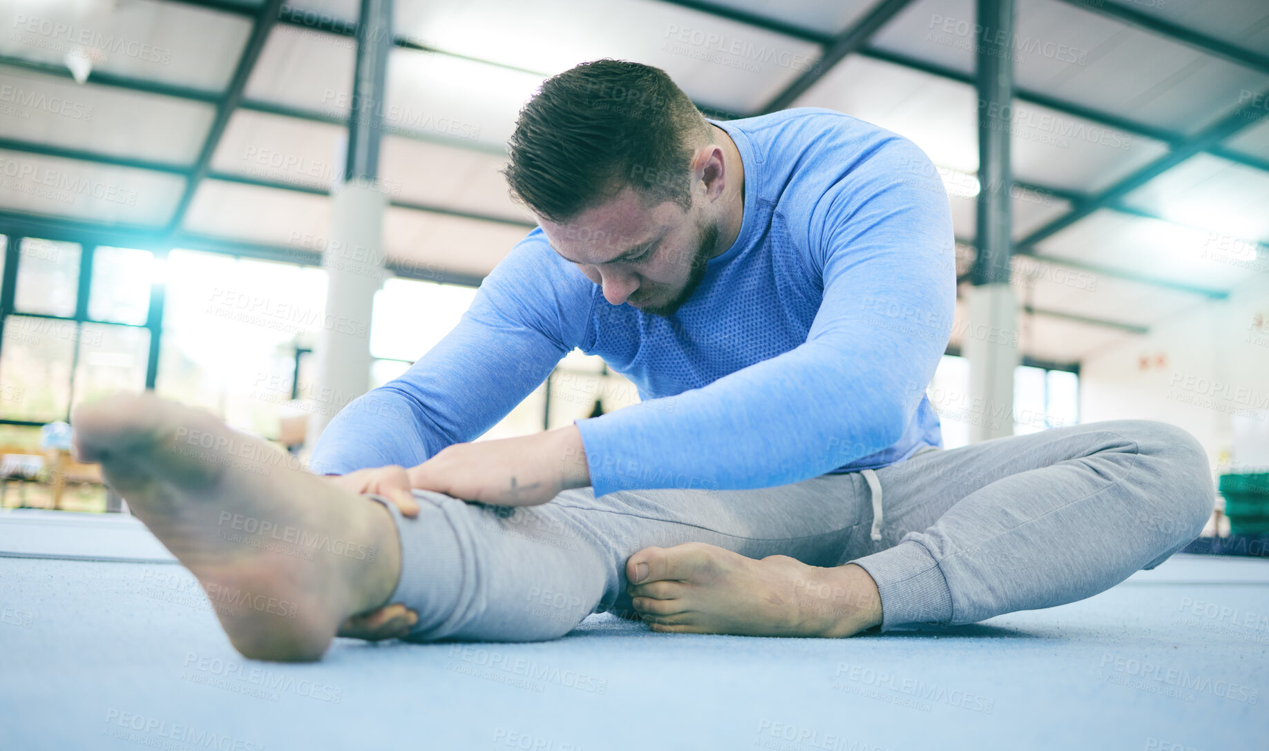 Buy stock photo Man, gymnastics or stretching legs on training floor, studio arena or fitness practice for competition flexibility or dynamic art. Rhythmic gymnast, athlete or warm up exercise in dance sports health