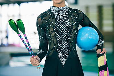 Rhythmic gymnast, dancer and gymnastic equipment in a gym for a performance exercise. Fitness, girl training and sequin dance suit of a artist with a sport ball for a competition in a sports gym