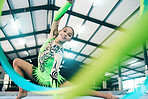 Woman, gymnastics and ribbon portrait in performance training, creative exercise or fitness practice for dynamic art. Smile, happy and rhythmic gymnast, athlete or equipment in dance sports workout