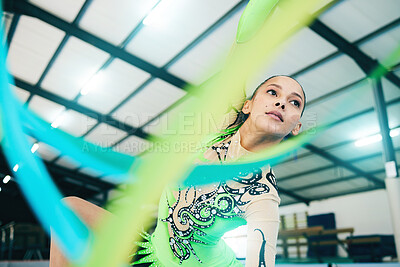 Buy stock photo Gymnastics, ribbon dancer and woman doing a sport, fitness and dance performance in a gym. Moving, competition and exercise of a young female busy with training and dancing workout in a arena