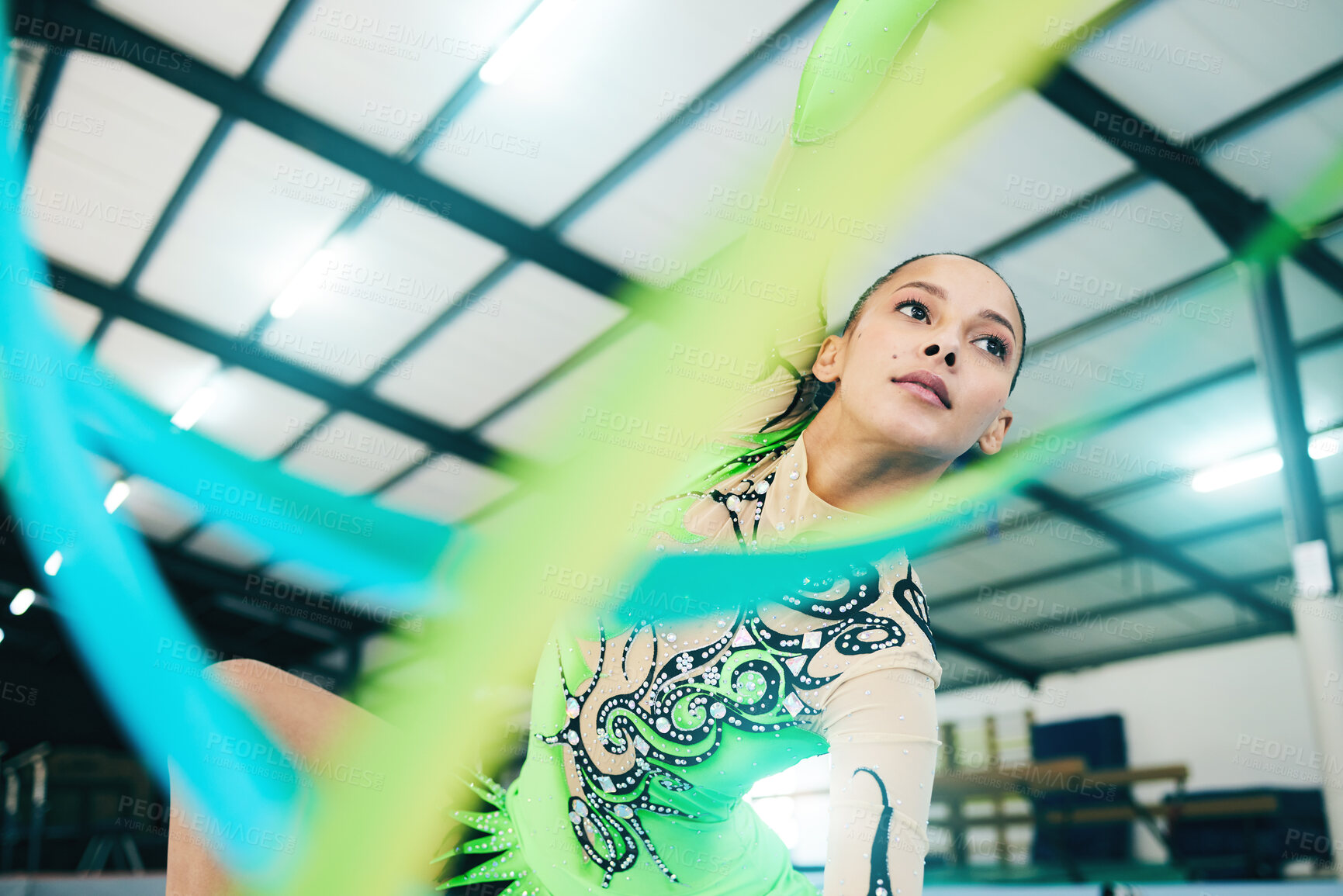 Buy stock photo Gymnastics, ribbon dancer and woman doing a sport, fitness and dance performance in a gym. Moving, competition and exercise of a young female busy with training and dancing workout in a arena