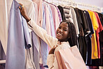 Retail, clothes and portrait of black woman shopping in a boutique, happy and smile while feeling fabric. Face, fashion and girl customer excited for clothing sale, discount or outfit choice in store