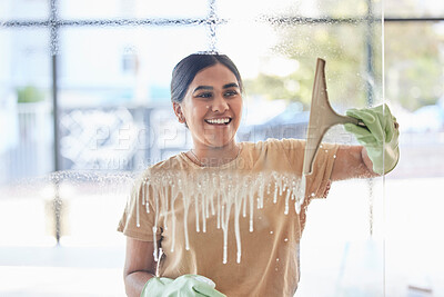 Buy stock photo Smile, happy and housekeeper cleaning window with spray bottle and soap or detergent, housekeeping in home or hotel. Housework, smudge and woman or cleaner service washing dirt off glass in apartment