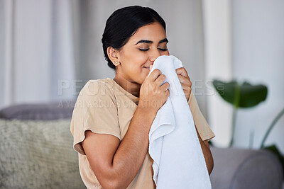 Buy stock photo House, cleaning and woman smelling laundry on a sofa, happy and relax alone in her home. Fresh, linen and smiling domestic worker excited for freshness, results and soft fabric  in household chores