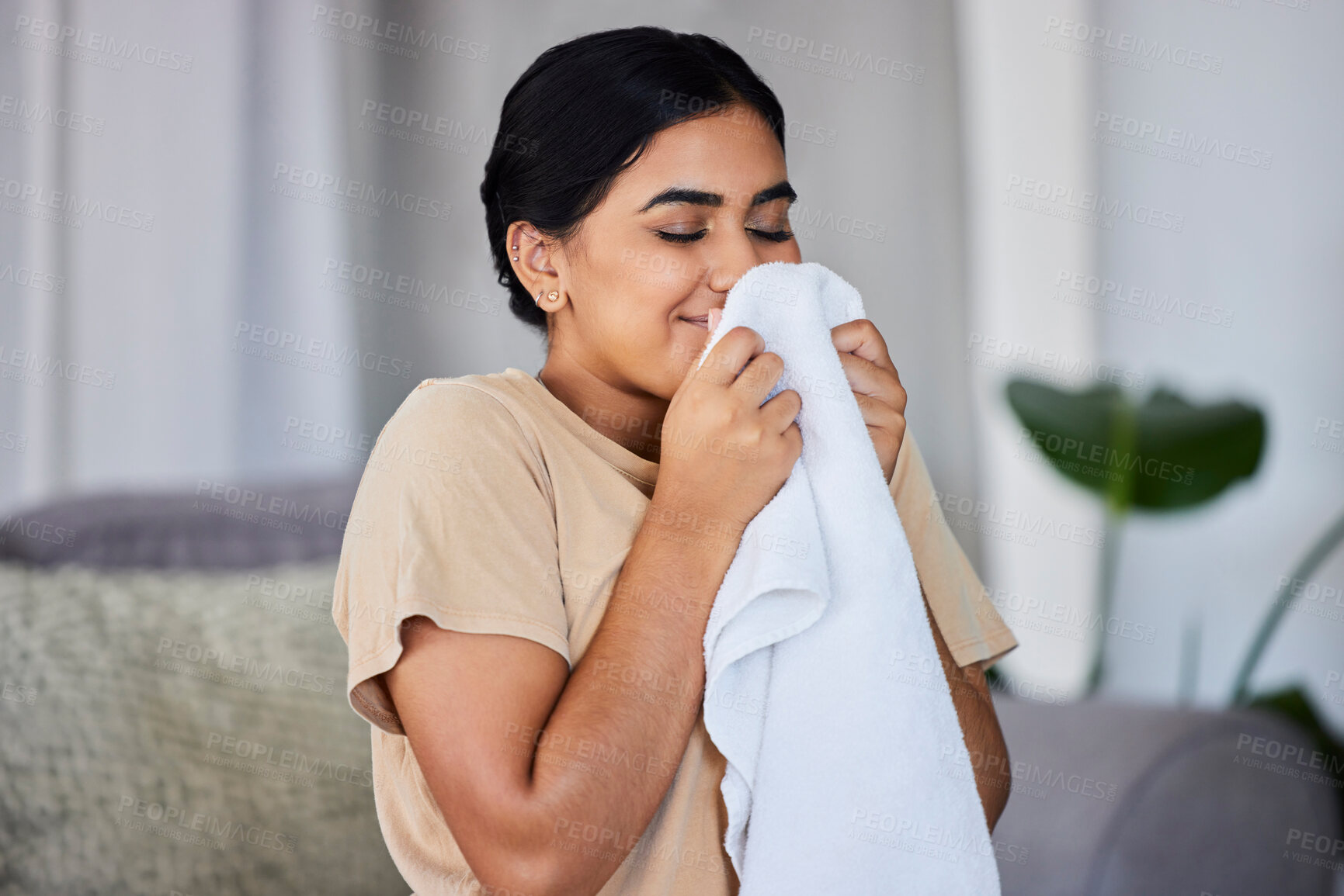 Buy stock photo House, cleaning and woman smelling laundry on a sofa, happy and relax alone in her home. Fresh, linen and smiling domestic worker excited for freshness, results and soft fabric  in household chores