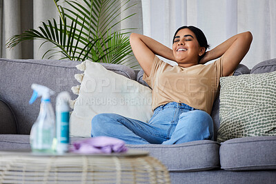Buy stock photo Woman, relax and sofa after cleaning house with smile, satisfaction and pride in home living room. Cleaner, rest and happy on lounge couch with spray, cloth and hygiene product on table in apartment