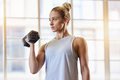 Bodybuilder, dumbbell and woman in a gym for training, sports and exercise for wellness. Thinking, sports focus and athlete with weights for fitness and health workout performance for muscle