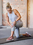 Woman with a knee injury, pain or accident at the gym while doing workout or sport training. Fitness, athlete and female with swollen, sore or sprain muscle in her leg after exercise in sports center