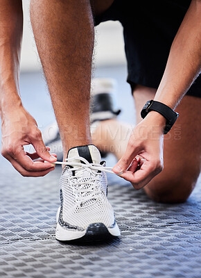 Buy stock photo Shoes, runner and man getting ready for training, exercise or running in sports sneakers, fashion and foot on floor. Feet of athlete or person tying his laces for cardio, fitness or workout in gym