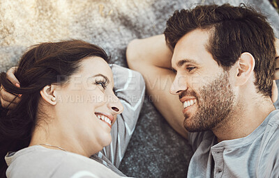 Buy stock photo Love, couple romance and relax, talking and having fun time together outdoors on valentines day. Trust, support and face of happy man and woman lying on romantic date, smile and having conversation.