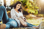 Love, relax and couple at park, laughing at funny joke or comic comedy and having fun together outdoors. Valentines day, romance cuddle and care of man lying on lap of happy woman on romantic date.