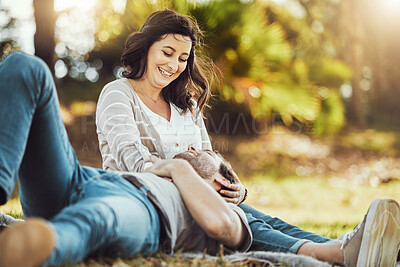 Buy stock photo Love, relax and couple at park, laughing at funny joke or comic comedy and having fun together outdoors. Valentines day, romance cuddle and care of man lying on lap of happy woman on romantic date.