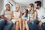 Big family, love and relax on sofa in home living room, bonding or enjoying quality time together. Communication, care and happy grandparents, father and mother talking to girl, child or kid in house