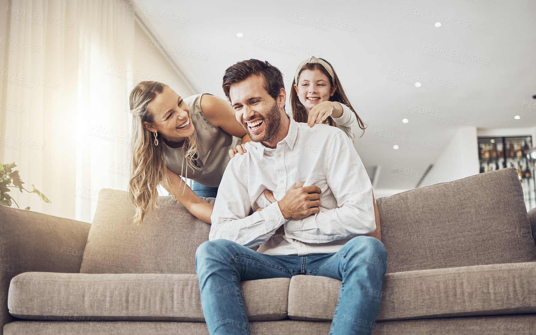 Buy stock photo Laughing, family or bonding in tickle game on home sofa, living room or house for funny, comic or comedy activity. Smile, happy or child ticking father with mother, mom or woman in silly or goofy fun