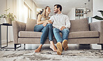 Love, comfy and couple on the sofa to relax with a smile and gratitude in living room. Happiness, laughing and happy man and woman comfortable on the couch for peace, conversation and affection