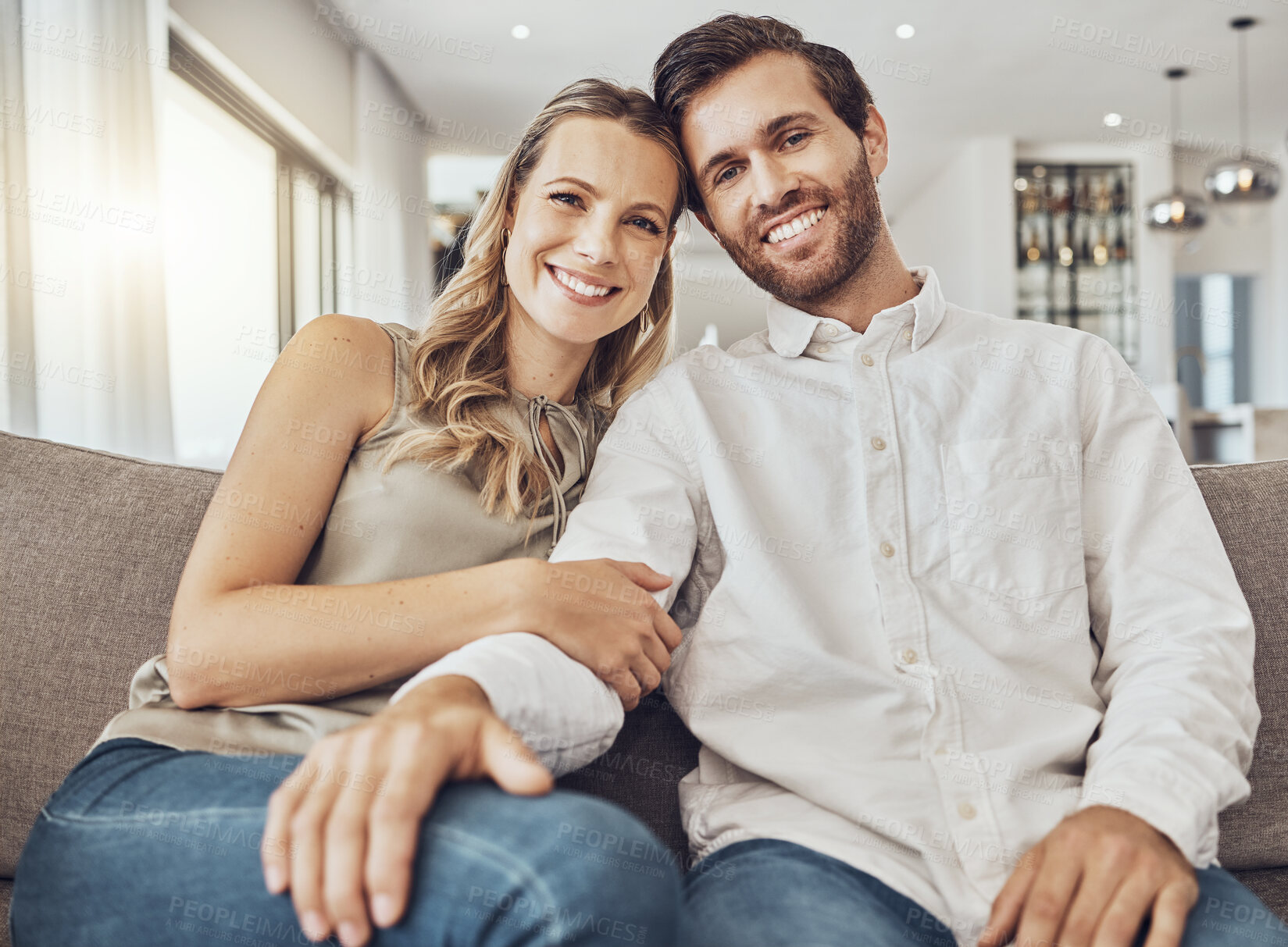 Buy stock photo Couple. portrait and home of young people together on a living room couch with love and care. Happiness, smile and hug of a man and woman on a sofa feeling relax in a house lounge with marriage