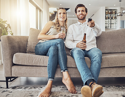 Buy stock photo Tv, couple and relax on sofa with alcohol streaming movie, film or video on valentines day. Champagne, beer or happy man and woman watching movies, online show or television and enjoying time in home