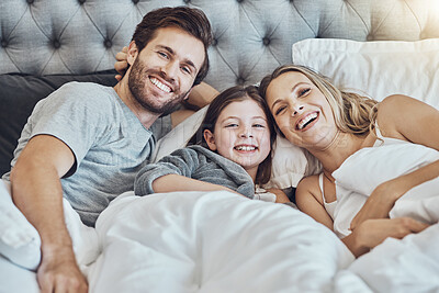 Buy stock photo Love, family and portrait in home bedroom, laughing at funny joke and bonding together. Care, comic and happy man, woman and girl, child or kid in bed, having fun and enjoying quality time in house.