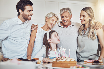 Buy stock photo Birthday party, cake and big family with girl in celebration of special event in house. Love, food and kid with happy father, mother and grandparents celebrating, talking and bonding in home kitchen.