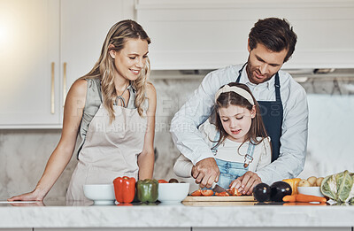 Buy stock photo Learning, parents or girl cooking or cutting vegetables as a happy family in a kitchen with organic food for dinner. Development, father or mother teaching or helping chop tomato with a healthy child