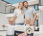 Real estate, house and portrait of family with keys and a sign for moving, property and homeowner. Happy, showing and parents with children, board and relocation after buying a new home from realtor