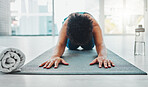 Yoga, stretching and fitness of a black woman in a gym for zen, relax and chakra exercise. Pilates, peace and meditation training of an athlete in prayer pose on the floor feeling calm from stretch