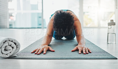 Buy stock photo Yoga, stretching and fitness of a black woman in a gym for zen, relax and chakra exercise. Pilates, peace and meditation training of an athlete in prayer pose on the floor feeling calm from stretch