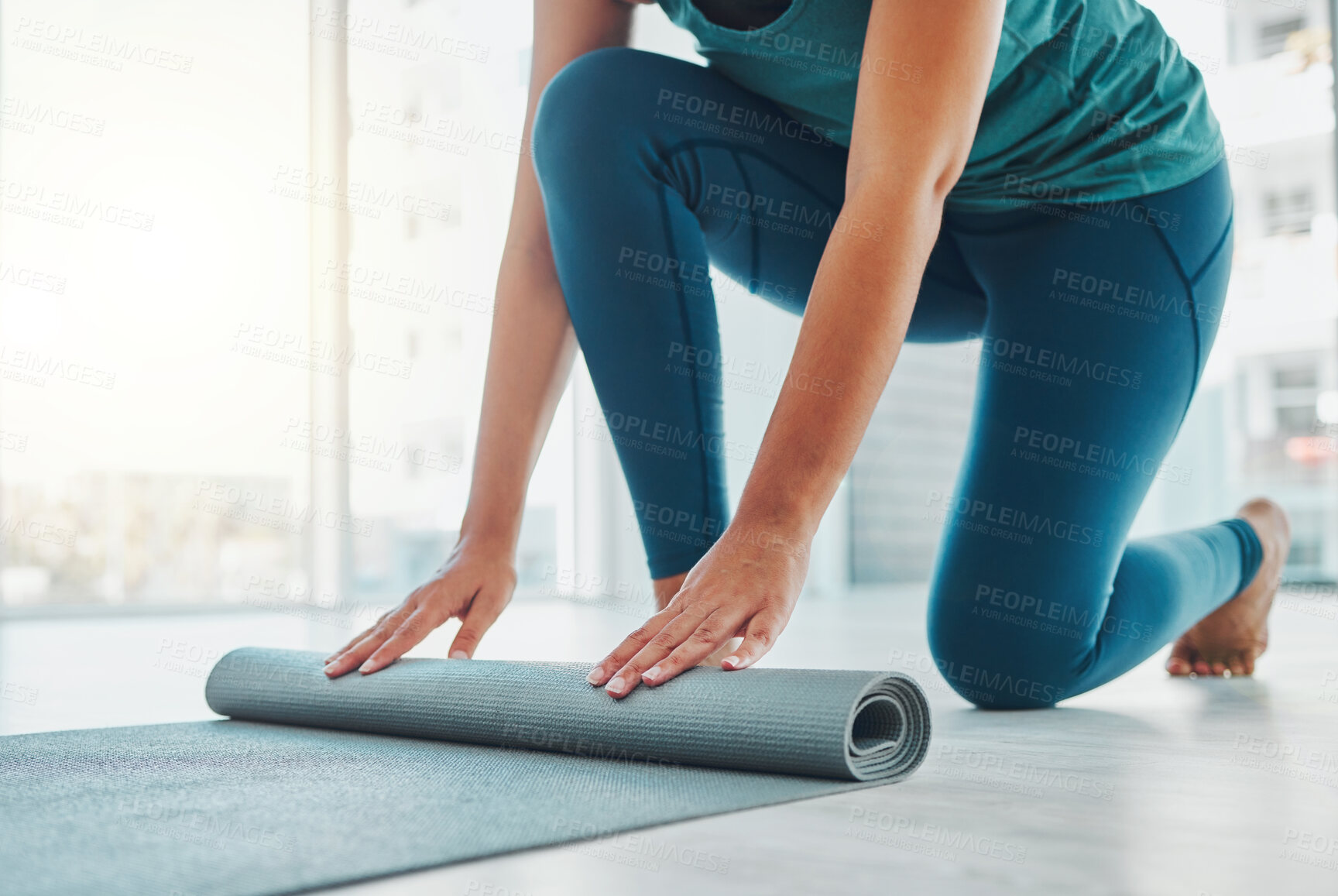 Buy stock photo Yoga, studio and exercise mat with the hands of a black woman at the start of a zen workout. Fitness, training and roll with a female yogi indoor for mental health, balance or spiritual wellness