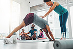 Yoga instructor, exercise and man in class for fitness, health and wellness workout. Healthy people in a pilates studio with a happy coach teaching stretching for body balance training with help