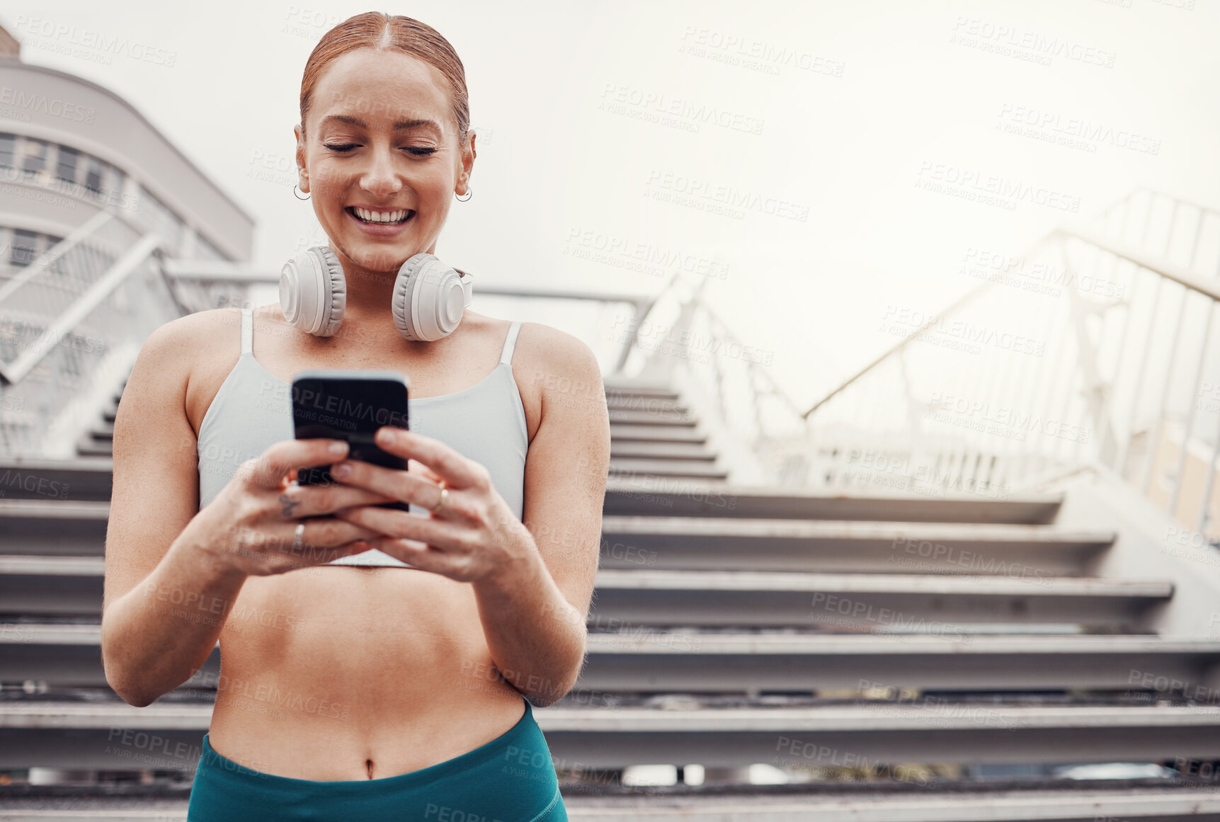 Buy stock photo City, workout and woman with smartphone, smile for communication, typing and headphones after exercise. Health, training and runner on 5g phone, fitness app to connect or network in sports.