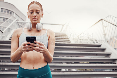 City, workout and woman with smartphone typing, communication, 5g and headphones after exercise. Health, training and personal trainer on phone texting, fitness app to connect or network in sports.