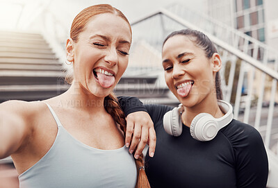 Buy stock photo Women, friends selfie and tongue in city for training, comic time or funny face with headphones in profile picture. Woman workout group, exercise photo or social media by stairs in metro with support