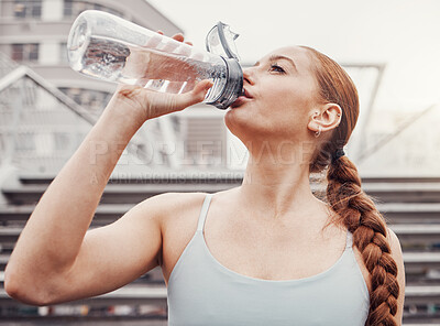Buy stock photo Fitness, hydration and a sports woman drinking water outdoor in the city during cardio or endurance exercise. Runner, workout and hydrated with a female athlete training in an urban town for health