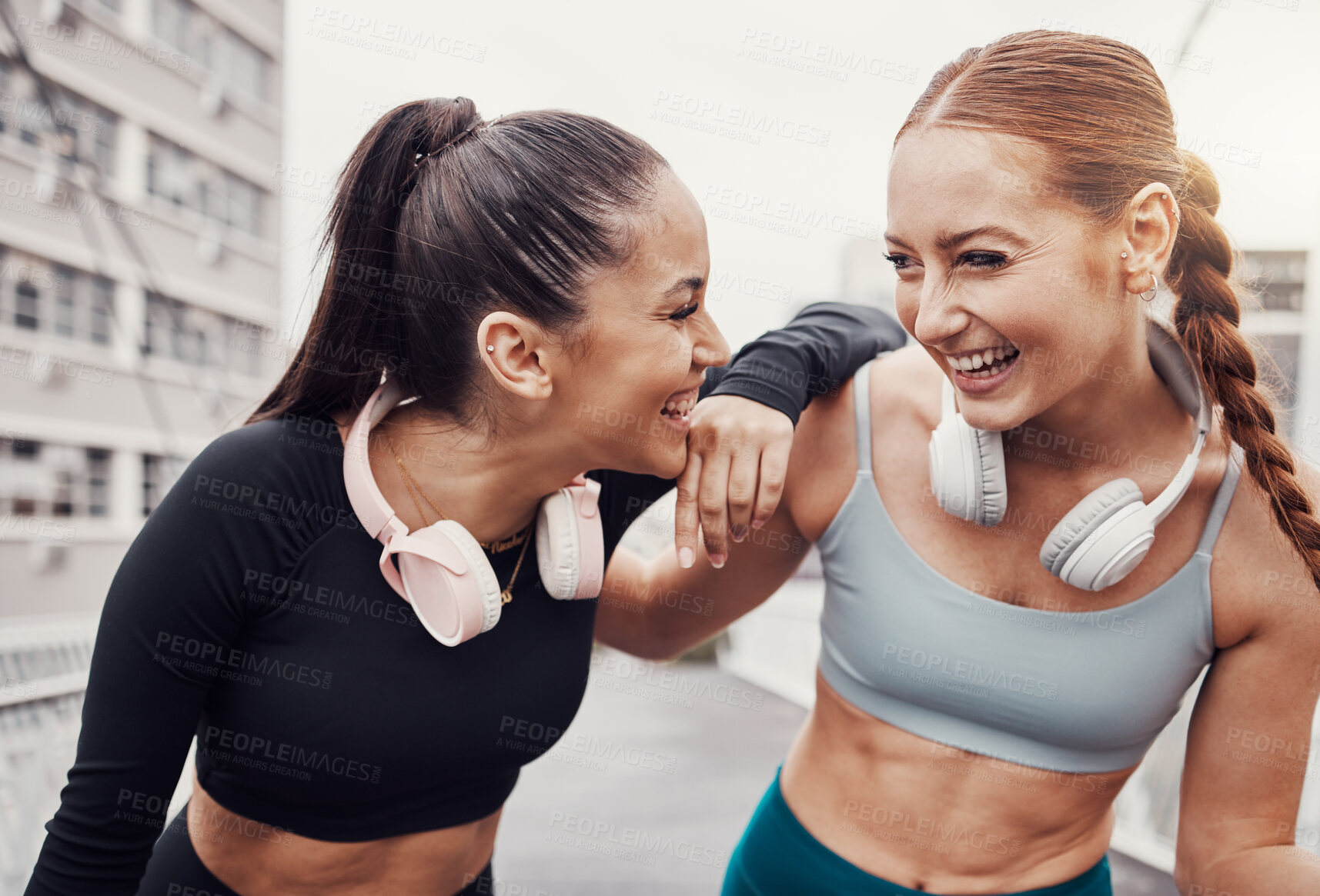 Buy stock photo Fitness, music and laugh with runner friends in the city for a cardio or endurance workout together. Exercise, running or happy with a female athlete and friend laughing outdoor in an urban town