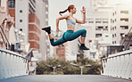 Workout, jump and health with woman in city for training, cardio and endurance. Energy, fitness and exercise with girl athlete and warm up in urban town for sports, running and body wellness