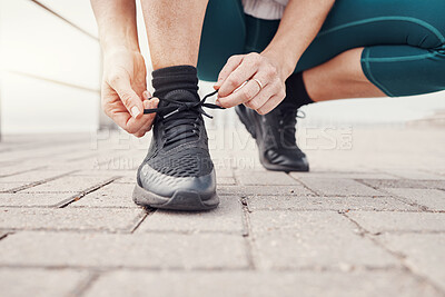 Buy stock photo Shoes, runner and woman getting ready for training, exercise or running in sports sneakers, fashion and urban street. Feet of athlete or person tying her laces for cardio, fitness or workout outdoor