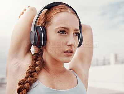 Buy stock photo Stretching, fitness and face of woman with headphones listening to music, podcast and audio for warm up. Running, sports and girl start workout, wellness exercise and marathon training in urban city