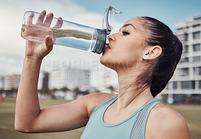 Buy stock photo Fitness, woman and drinking water in the city after running, exercise or cardio workout in Cape Town. Female runner with bottle and natural drink for thirst, hydration or aqua liquid for sports break