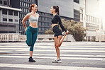 Fitness, woman and friends stretching in the city for running, cardio exercise or workout. Active women in warm up stretch together in preparation for exercising, run or sports workout in urban town